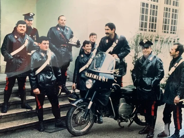 Carabinieri officers around a Carabinieri-liveried Moto Guzzi in Italy