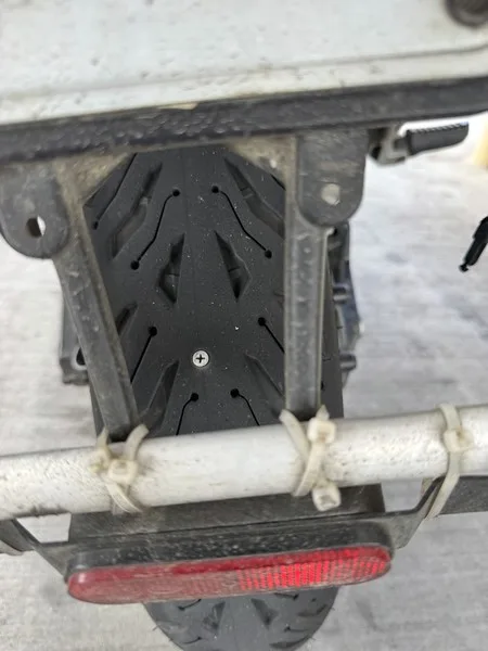 A screw lodged in the rear tire tread